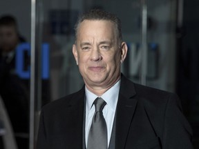 FILE - In this Jan. 10, 2018 file photo, actor Tom Hanks poses for photographers at the premiere of "The Post" in London. It's a beautiful day in this neighborhood for Tom Hanks. The actor will star as Mr. Rogers in the upcoming biopic "You Are My Friend." TriStar Pictures announced Monday, jan. 29, 2018,  that it has acquired worldwide rights to the film, to be directed by "Diary of a Teenage Girl" filmmaker Marielle Heller.