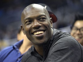 In this Oct. 23, 2015 photo, former NFL football player Terrell Owens watches the action from court side seats during the second half of a preseason NBA basketball game between the Orlando Magic and the Memphis Grizzlies in Orlando, Fla. When Pro Football Hall of Fame voters meet the day before the Super Bowl to choose the Class of 2018, the decision to select Terrell Owens should take less than it does to microwave a bag of popcorn. T.O. belongs in Canton. It's a no-brainer.