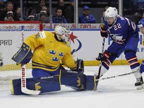 United States forward Logan Brown (22) is stopped by Sweden goalie Filip Gustavsson (30) during the first period of a semifinal game at the world junior hockey championship in Buffalo, N.Y., Thursday, Jan. 4, 2018.