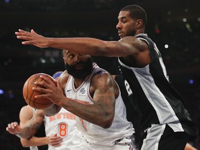 New York Knicks center Kyle O'Quinn (9) looks to shoot against San Antonio Spurs forward LaMarcus Aldridge (12) during the second quarter of an NBA basketball game, Tuesday, Jan. 2, 2018, in New York.