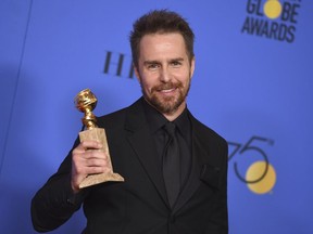 FILE- In this Jan. 7, 2018, file photo, Sam Rockwell poses in the press room with the award for best performance by an actor in a supporting role in any motion picture for "Three Billboards Outside Ebbing, Missouri" at the 75th annual Golden Globe Awards at the Beverly Hilton Hotel in Beverly Hills, Calif.  On "Saturday Night Live," guest host Rockwell let an expletive slip during a skit on Saturday, Jan. 13, 2018. He then put his hand to his mouth and said "sorry" before continuing with the skit.