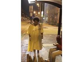 FILE- This Tuesday, Jan. 9, 2018, file still image taken from video provided by Imamu Baraka shows a woman discharged from a Baltimore hospital wearing only a gown and socks on a cold winter's night. An attorney for the woman who was left outside a Baltimore hospital wearing a patient gown and socks on a frigid night says she was having a psychotic episode when the institution turned its back on her. Hospital officials say they are still investigating why the woman was escorted out of the hospital by uniformed security personnel and left at a city bus stop.