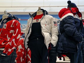 A white parka, center, designed by David Lauren for Polo Ralph Lauren is shown in the brand's Prince Street store, Monday, Jan. 22, 2018, in New York. The jacket is part of Team USA's closing ceremony uniform for the upcoming Winter Olympics in Pyeongchang, South Korea.