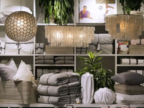 In this Monday, Jan. 22, 2018, photo, lamps from the Philippines, made of seashells, hang over a display of artisanal items, at a West Elm store in New York. On the lower shelf are: a basket from India, left; paper mache vases from Haiti, center; and pillows from India, right. There have been growing initiatives to help artisans from some of the poorest global regions gain access to the U.S. market to spur economic development in their countries and provide economic opportunities, especially for women. Big name retailers like Macy's and West Elm are getting in the game.