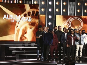Bruno Mars, front center, accepts the award for album of the year for "24K Magic" at the 60th annual Grammy Awards at Madison Square Garden on Sunday, Jan. 28, 2018, in New York.