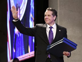 FILE - In this Wednesday, Jan. 3, 2018, file photo, New York Gov. Andrew Cuomo waves before delivering his state of the state address at the Empire State Plaza Convention Center in Albany, N.Y. Billing himself as the progressive who gets stuff done, Cuomo blasted President Donald Trump and Washington Republicans, contrasting the turmoil in the federal government with his accomplishments as leader of the nation's fourth largest state.