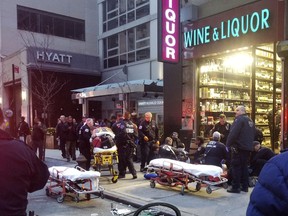 In this photo provided by David Markovich, police respond to the scene of a shooting Sunday, Jan. 21, 2018, in front of a liquor store adjacent to a Hyatt Hotel in midtown Manhattan.