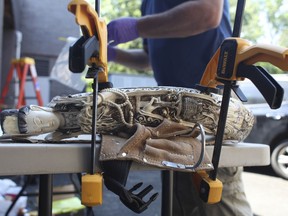 In this Aug. 1, 2017 photo, a carved ivory goddess statue is clamped to a work table in preparation for a sample to be cut from it for scientific analysis at the Lamont-Doherty Earth Observatory of Columbia University in Palisades, N.Y. The statue was among the $4.5 million in artifacts seized from a Manhattan antiques shop and crushed in Central Park in August 2017. Scientists will test it to determine where and when the elephant was slaughtered. (Wild Tomorrow Fund via AP)