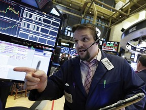 Trader Michael Milano works on the floor of the New York Stock Exchange, Wednesday, Jan. 31, 2018. Stocks are opening solidly higher on Wall Street after a number of big U.S. companies reported strong quarterly earnings.