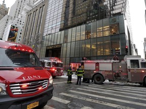 New York City Fire Department vehicles sit on Fifth Avenue in front of Trump Tower, in New York, Monday, Jan. 8, 2018. The department said a fire started around 7 a.m. Monday in the heating and air conditioning system of the building.