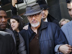File-This March 9, 2017, file photo shows Ravi Ragbir, executive director of the New Sanctuary Coalition, being escorted by supporters after his annual check-in with Immigration and Customs Enforcement, in New York. U.S. Rep. Nydia Velazquez has invited the wife of detained immigrant rights activist Ravi Ragbir to President Donald Trump's State of the Union address. Ragbir was in federal custody Saturday, several weeks after he was arrested during a routine check-in with the Immigration and Customs Enforcement agency. On Saturday, Velazquez, a Democrat, joined Ragbir's wife, Amy Gottlieb, and other elected officials at a rally in front of the Manhattan office building that houses ICE.