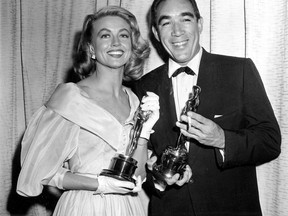 File-This March 27, 1957, file photo shows Best supporting Oscar winners Dorothy Malone and Anthony Quinn posing at the Academy Awards in Hollywood, Calif. Malone, who won hearts of 1960s television viewers as the long-suffering mother in the nighttime soap "Peyton Place," has died. Her daughter Mimi Vanderstraaten says Malone died Friday, Jan. 19, 2018, from natural causes in her hometown of Dallas. She was 93. (AP Photo, File)