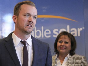 File- This Feb. 1, 2017, file photo shows Affordable Solar president Kevin Bassalleck talking about the full-time positions his company will create as Gov. Susana Martinez listens during a news conference in Albuquerque, N.M. Some in the U.S. solar-power industry are hoping a decision this week by President Donald Trump doesn't bring on an eclipse. Companies that install solar-power systems for homeowners and utilities are bracing for Trump's call on whether to slap tariffs on imported panels. Bassalleck, said tariffs would hurt homegrown companies that make racks, tracking systems and electronics that are part of a power system. He said jobs at those companies are hard to outsource.