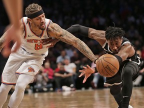 New York Knicks' Michael Beasley, left, and Brooklyn Nets' Rondae Hollis-Jefferson fight for a loose ball during the first half of the NBA basketball game at the Barclays Center, Monday, Jan. 15, 2018 in New York.