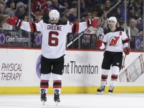 New Jersey Devils' Travis Zajac, right, celebrates his goal with Andy Greene during the second period of an NHL hockey game against the New York Islanders, Sunday, Jan. 7, 2018, in New York.