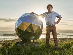 In this Nov. 2017 photo provided by Rocket Lab, Rocket Lab founder and CEO Peter Beck is pictured with his "Humanity Star" in Auckland, New Zealand. Beck, the founder of the company that this week launched the first rocket into orbit from New Zealand said on Wednesday, Jan 24, 2018, that he had deployed a secret satellite he believes will be the brightest object in the night sky and which he hopes will remind people of their precarious place in a vast universe.