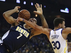 Denver Nuggets' Trey Lyles, left, is fouled by Golden State Warriors' Stephen Curry (30) during the first half of an NBA basketball game Monday, Jan. 8, 2018, in Oakland, Calif.