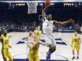 Xavier's Quentin Goodin (3) dunks in the first half of an NCAA college basketball game against Marquette, Wednesday, Jan. 24, 2018, in Cincinnati.