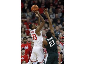 Ohio State forward Keita Bates-Diop, left, goes up to shoot against Michigan State forward Xavier Tillman during the first half of an NCAA college basketball game in Columbus, Ohio, Sunday, Jan. 7, 2018.