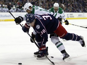 Columbus Blue Jackets forward Boone Jenner (38) works for the puck against Dallas Stars forward Jamie Benn during the first period of an NHL hockey game in Columbus, Ohio, Thursday, Jan. 18, 2018.