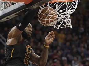 Cleveland Cavaliers' LeBron James dunks the ball against the Oklahoma City Thunder in the first half of an NBA basketball game, Saturday, Jan. 20, 2018, in Cleveland.