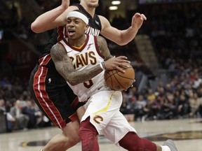 Cleveland Cavaliers' Isaiah Thomas, left, drives to the basket against Miami Heat's Kelly Olynyk in the first half of an NBA basketball game, Wednesday, Jan. 31, 2018, in Cleveland.