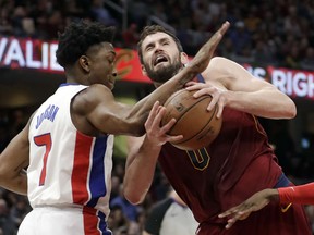 Detroit Pistons' Stanley Johnson, left, fouls Cleveland Cavaliers' Kevin Love in the first half of an NBA basketball game, Sunday, Jan. 28, 2018, in Cleveland.