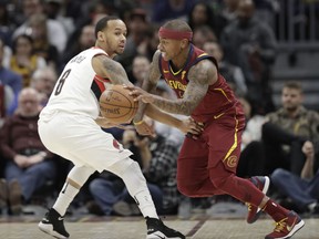 Cleveland Cavaliers' Isaiah Thomas, right, drives past Portland Trail Blazers' Al-Farouq Aminu in the first half of an NBA basketball game, Tuesday, Jan. 2, 2018, in Cleveland.