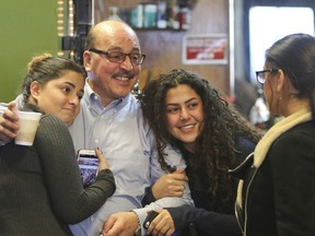In this Jan. 2, 2018, photo, owner of Downtown Circle Convenience and Deli Amer Adi Othman, known locally as Al Adi, second from left, stands with his daughters in Youngstown, Ohio. U.S. Immigration and Customs Enforcement said Thursday, Jan. 25, that Othman, who facing deportation to his native Jordan, won't be granted a deportation delay and will remain in custody pending removal from the United States.