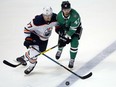 Edmonton Oilers defenceman Oscar Klefbom and the Stars' Alexander Radulov fight for the puck during the third period of their game in Dallas on Saturday night. The Stars won-5-1.