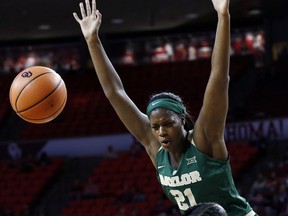 Baylor center Kalani Brown (21) loses the ball after a foul by Oklahoma center Vionise Pierre-Louis, bottom, in the first quarter of an NCAA college basketball game in Norman, Okla., Sunday, Jan. 14, 2018.