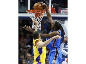 Oklahoma City Thunder forward Jerami Grant, right, dunks in front of Los Angeles Lakers forward Larry Nance Jr., left, in the first half of an NBA basketball game in Oklahoma City, Wednesday, Jan. 17, 2018.