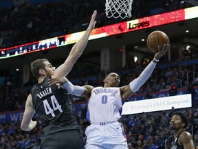 Oklahoma City Thunder guard Russell Westbrook (0) shoots in front of Brooklyn Nets center Tyler Zeller (44) during the first half of an NBA basketball game in Oklahoma City, Tuesday, Jan. 23, 2018.