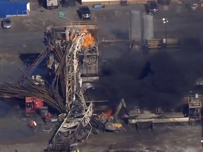 FILE - In this Jan. 22, 2018 file photo provided from a frame grab by Tulsa's KOTV/NewsOn6.com, fires burn at an eastern Oklahoma drilling rig near Quinton, Okla. Five people workers were killed after a fiery explosion ripped through a drilling rig, sending plumes of black smoke into the air and leaving a derrick crumpled on the ground, emergency officials said. Federal records show 10 workers have died over the past decade at well sites linked Patterson-UTI, the same driller involved in this week's rig explosion.