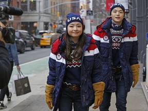 Ice dancing pair and sister and brother Maia and Alex Shibutani, who will participate in the upcoming winter Olympics in Pyeongchang, South Korea, model Team USA's opening ceremony uniforms for a cameraman on the street outside Polo Ralph Lauren's Prince Street store, Monday, Jan. 22, 2018, in New York.