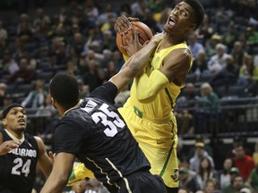 Colorado's George King, left, watches teammate Dallas Walton vie with Oregon's Kenny Wooten for a rebound during the first half of an NCAA college basketball game Sunday, Dec. 31, 2017, in Eugene, Ore.