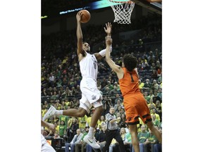Oregon's Troy Brown Jr., left, shoots over Oregon State's Stephen Thompson Jr. during the first half of an NCAA college basketball game Saturday, Jan. 27, 2018, in Eugene, Ore.