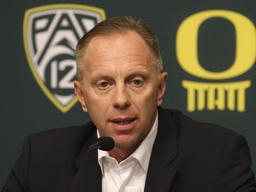 FILE - In this Nov. 29, 2016, file photo, Oregon athletic director Rob Mullens talks to the media in Eugene, Ore., after the firing NCAA college football head coach Mark Helfrich. Mullens will become the new chairman of the College Football Playoff selection committee starting next season, and three new Power Five ADs will join the 13-member panel.