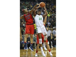 Oregon's Ruthy Hebard scores as she is fouled by Arizona forward Sam Thomas during an NCAA college basketball game in Eugene, Ore., Friday, Jan. 12, 2018.