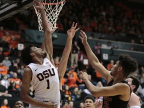 Oregon State's Stephen Thompson Jr. (1) gets behind Southern California's Bennie Boatwright (25) for a basket in the first half of an NCAA college basketball game in Corvallis, Ore., Saturday, Jan. 20, 2018.