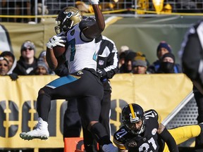 Jacksonville Jaguars running back Leonard Fournette (27) makes it into the end zone for a touchdown with Pittsburgh Steelers cornerback Joe Haden (21) defending during the first half of an NFL divisional football AFC playoff game in Pittsburgh, Sunday, Jan. 14, 2018.