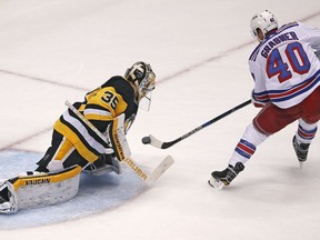 New York Rangers' Michael Grabner (40) backhands a shot on a breakaway past Pittsburgh Penguins goaltender Tristan Jarry (35) in the first period of an NHL hockey game in Pittsburgh, Sunday, Jan. 14, 2018.