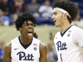 Pittsburgh guard Marcus Carr (5) celebrates with teammate Parker Stewart (1) following a basket against Georgia Tech in the first half of an NCAA college basketball game, Saturday, Jan. 13, 2018, in Pittsburgh.