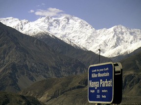 FILE - In this May 4, 2004 file photo, Nanga Parbat, the ninth highest mountain in the world, is seen in Pakistan's northern area. A Pakistani official said Sunday, Jan. 28, 2018, that volunteers were able to rescue Elisabeth Revol, a French mountaineer from the Himalayan peak but because of poor weather called off efforts to retrieve a Polish climber, Tomasz Mackiewicz, who was suffering from snow blindness and altitude sickness.