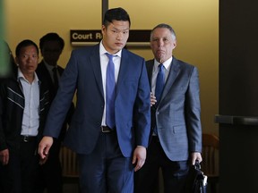 FILE – In this May 15, 2017, file photo, Raymond Lam, center, leaves the Monroe County Courthouse in Stroudsburg, Pa. Lam is one of four men from the New York City borough of Queens who pleaded guilty to involuntary manslaughter in the 2013 death of Chun "Michael" Deng, a fraternity pledge from the Baruch College campus of the City University of New York, at a rented house in the Pocono Mountains. The four are set to be sentenced Monday, Jan. 8, 2018, along with the Pi Delta Psi fraternity itself, which was convicted after a trial.