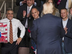 FILE - In this Dec. 15, 2016, file photo, U.S. Rep. Lou Barletta, R-Pa., left, U.S. Rep. Tom Marino, R-Pa., center left, and U.S. Rep. Scott Perry, R-Pa., right, watch as President-elect Donald Trump, center right, departs a rally in Hershey, Pa. The Democratic-controlled Pennsylvania Supreme Court struck down the state's congressional map in a 4-3 decision Monday, Jan. 22, 2018, granting a major victory to Democrats who charged that the 18 districts were unconstitutionally gerrymandered to benefit Republicans.