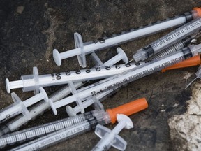 FILE - This July 31, 2017, file photo shows discarded syringes in an open-air heroin market that has thrived for decades, slated for cleanup along train tracks a few miles outside the heart of Philadelphia. Philadelphia wants to become the first U.S. city to allow supervised drug injection sites as a way to combat the opioid epidemic, city officials announced Tuesday, Jan. 23, 2018, saying they would seek outside operators to establish one or more safe injection sites.