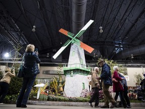 FILE - In this March 10, 2017, file photo, visitors view a horticultural display by Mercer County Community College during a preview of the annual Philadelphia Flower Show, featuring the theme "Holland: Flowering the World," at the Pennsylvania Convention Center in Philadelphia. As the East Coast slogs through chilly temperatures and winter dreariness, visitors will dive into spring during the annual Philadelphia Flower Show from March 3 to 11, 2018, featuring the theme "Wonders of Water" and promising to "celebrate the beauty and life-sustaining interplay of horticulture and water."