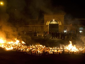 Prison guards protest by burning pallets outside the Fresnes prison, where Jawad Bendaoud is expected to be jailed, outside Paris, Wednesday Jan.24, 2018. The trial of Bendaoud accused of providing assistance to the suspected ringleader of the Paris attacks could be disrupted by prison guards protesting their working conditions.