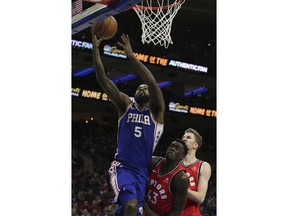 Philadelphia 76ers forward Amir Johnson (5) attempts a shot in front of Toronto Raptors forward Pascal Siakam (43) during the third quarter of an NBA basketball game in Philadelphia, Monday, Jan. 15, 2018. The 76ers won 117-111.